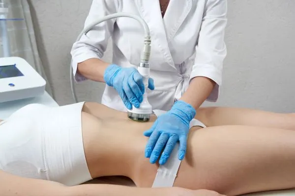 Lost the Weight but Not the Loose Skin? 2 woman having HIFU treatment on her stomach to combat loose skin Woburn Sands following weight loss